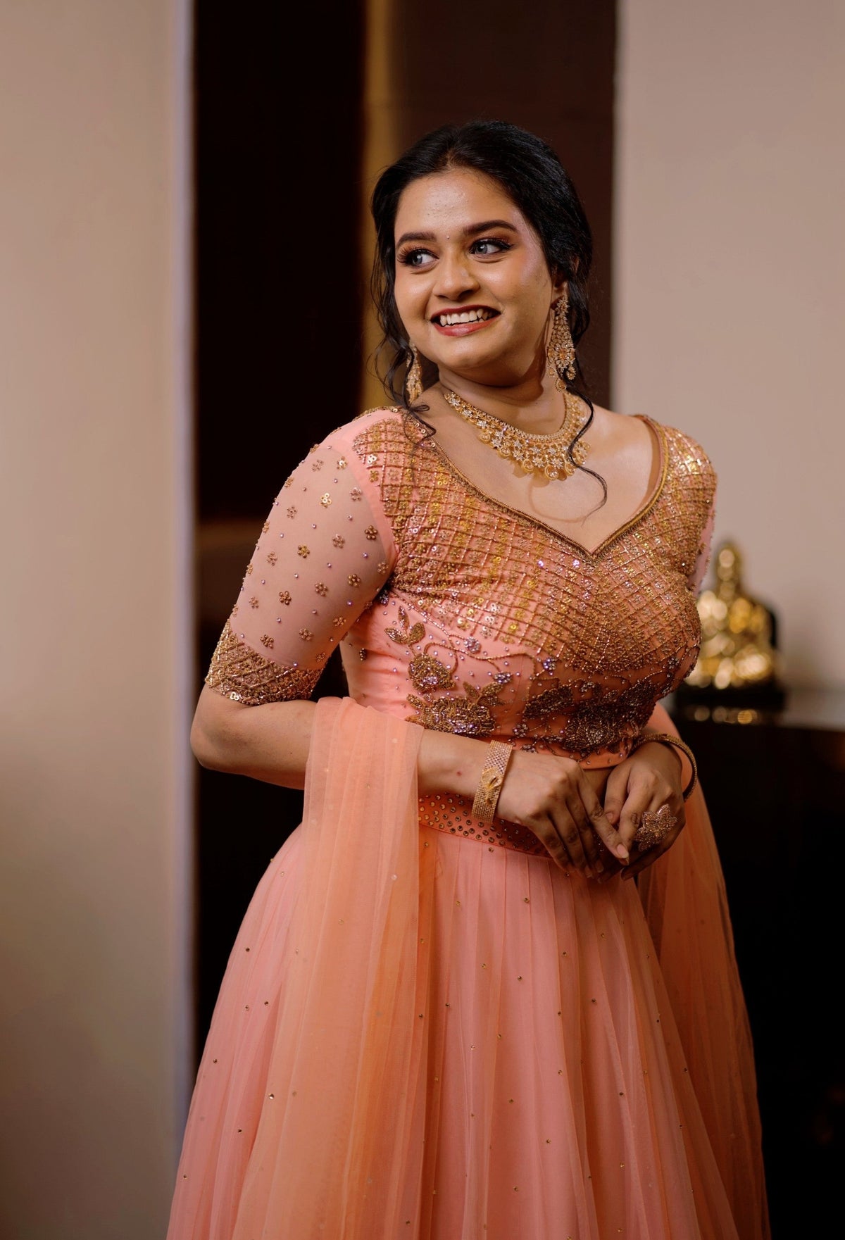 Peach Bridal Lehenga Detailed with Golden Zardozi & Sequence Work